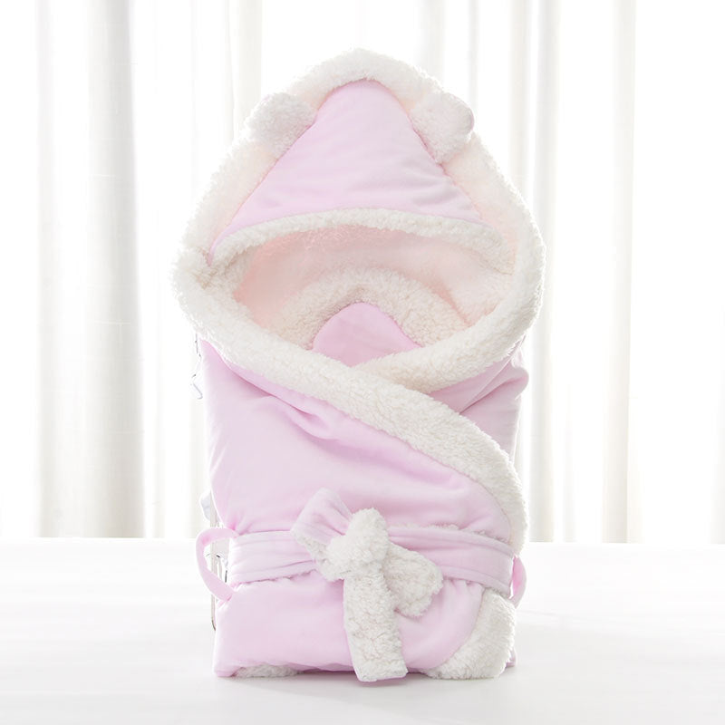 Newborn baby being hugged and swaddled by baby My Store